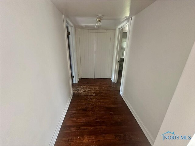 228 Harris St, Elmore, OH 43416 - corridor featuring dark wood-style flooring and baseboards