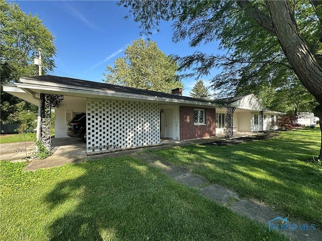 101 Maplewood Dr, Pandora, OH 45877 - back of house with a lawn and an attached carport
