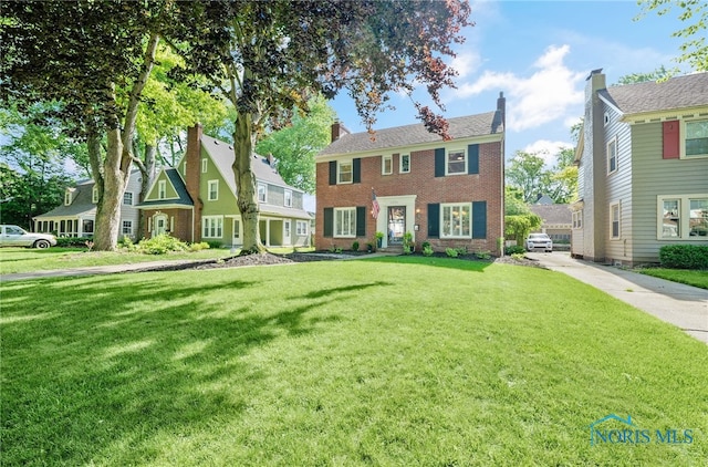 2230 Middlesex Dr, Toledo, OH 43606 - colonial house with a front yard and brick siding