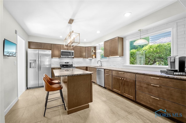 2230 Middlesex Dr, Toledo, OH 43606 - kitchen with stainless steel appliances, tasteful backsplash, plenty of natural light, open shelves, and recessed lighting