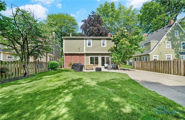 2230 Middlesex Dr, Toledo, OH 43606 - back of property with a patio area, brick siding, and a chimney