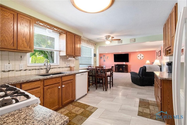 2204 Longport Dr, Maumee, OH 43537 - kitchen with white dishwasher, brown cabinetry, and open floor plan