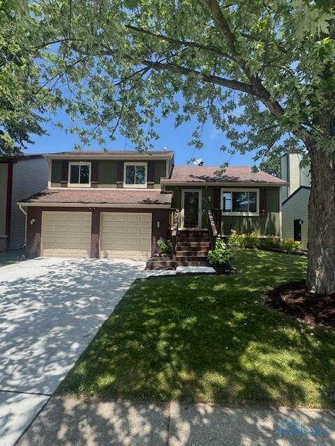 4504 Cherry Creek Ln, Toledo, OH 43615 - split level home featuring driveway, a front lawn, and a garage