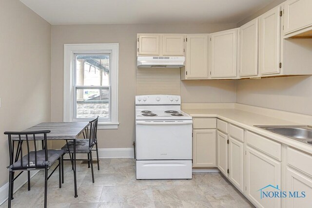 2529 Foraker Ave, Toledo, OH 43609 - kitchen featuring white electric stove, under cabinet range hood, light countertops, and white cabinetry
