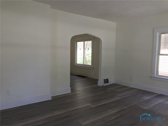 422 E Lake St, Toledo, OH 43608 - spare room featuring arched walkways and dark wood finished floors