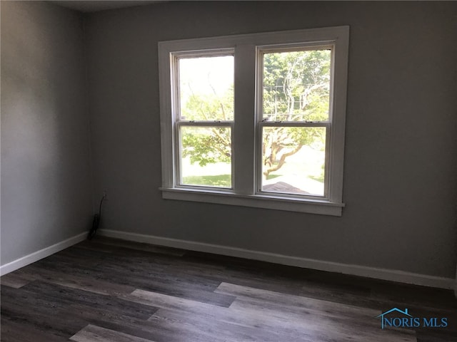 422 E Lake St, Toledo, OH 43608 - empty room featuring baseboards and dark wood-style floors