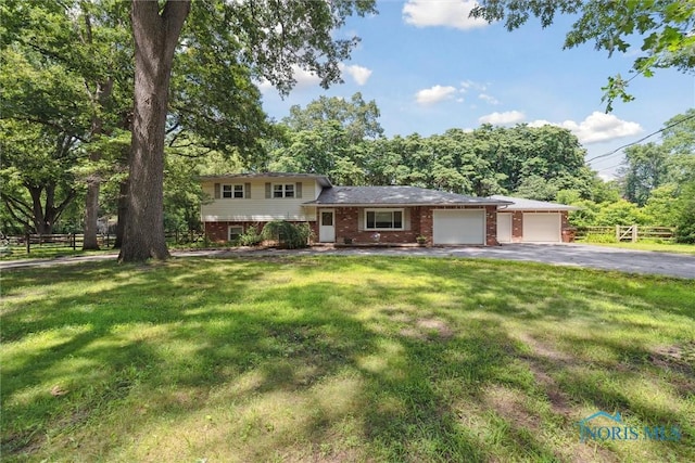 7948 Holstein Rd, Toledo, OH 43617 - tri-level home featuring brick siding, a garage, and driveway