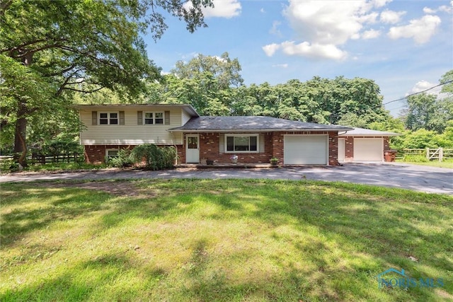 7948 Holstein Rd, Toledo, OH 43617 - split level home featuring brick siding, asphalt driveway, and an attached garage