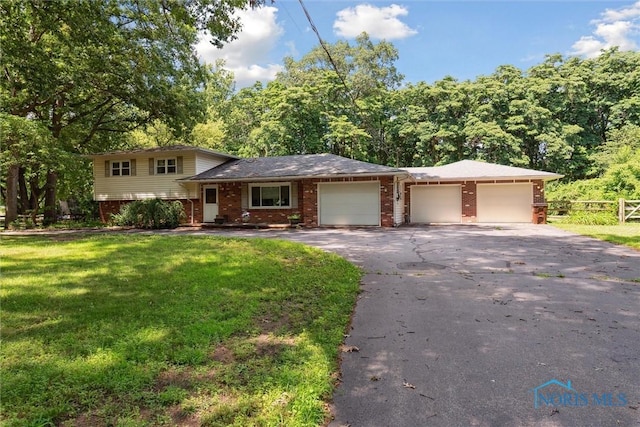 7948 Holstein Rd, Toledo, OH 43617 - split level home with brick siding, a garage, and asphalt driveway