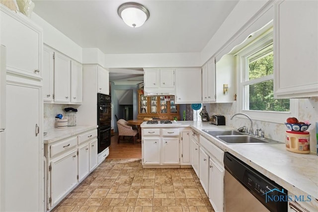 7948 Holstein Rd, Toledo, OH 43617 - kitchen with dishwasher, white cabinets, light countertops, and decorative backsplash