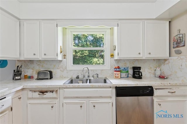 7948 Holstein Rd, Toledo, OH 43617 - kitchen featuring stainless steel dishwasher, white cabinets, and light countertops