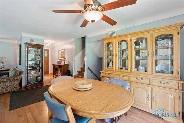 7948 Holstein Rd, Toledo, OH 43617 - dining room featuring stairway, light wood-style floors, and ceiling fan
