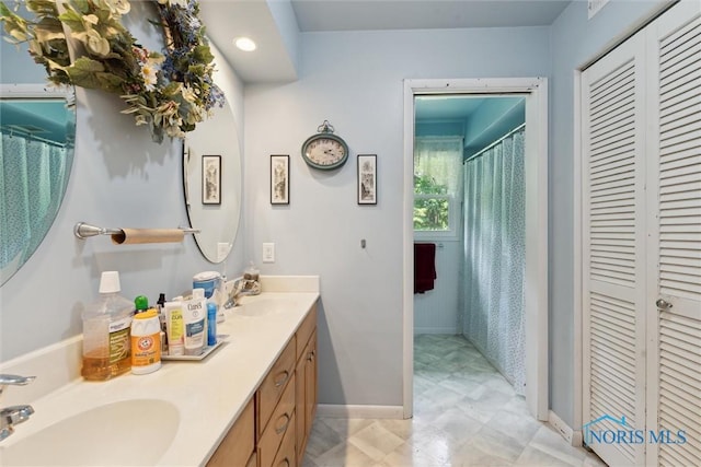 7948 Holstein Rd, Toledo, OH 43617 - full bath featuring a closet, double vanity, a shower with shower curtain, and recessed lighting