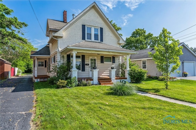 1022 E Sandusky St, Findlay, OH 45840 - victorian-style house with covered porch, a chimney, a front yard, and driveway