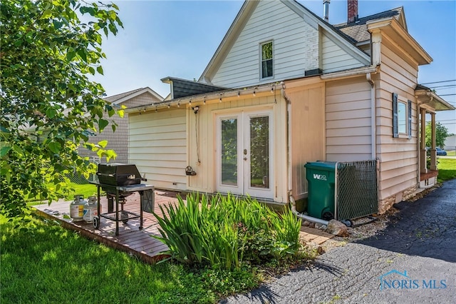 1022 E Sandusky St, Findlay, OH 45840 - rear view of house featuring a chimney, french doors, and a wooden deck