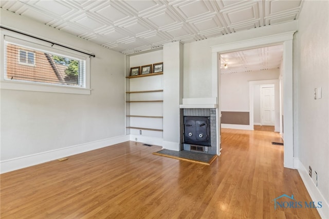 1022 E Sandusky St, Findlay, OH 45840 - unfurnished living room with light wood finished floors, built in shelves, and an ornate ceiling