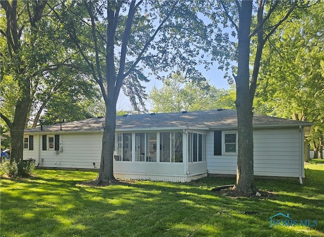 13876 Kay St, Paulding, OH 45879 - back of property featuring a sunroom and a lawn