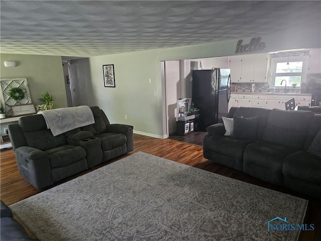 13876 Kay St, Paulding, OH 45879 - living area with dark wood-type flooring and a textured ceiling