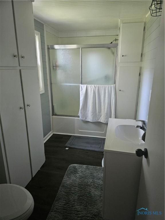 13876 Kay St, Paulding, OH 45879 - full bath with shower / bath combination with glass door, vanity, and wood finished floors
