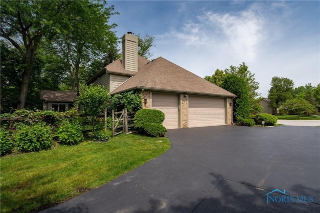5301 River Oaks Ct, Sylvania, OH 43560 - view of side of home with a chimney, brick siding, a yard, and a shingled roof