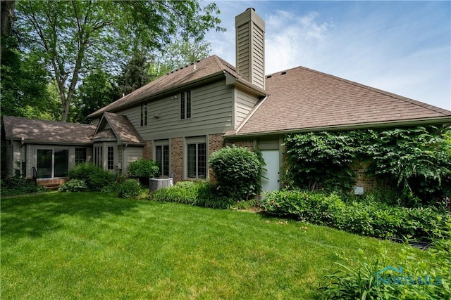 5301 River Oaks Ct, Sylvania, OH 43560 - back of property featuring a chimney, a yard, brick siding, and a shingled roof