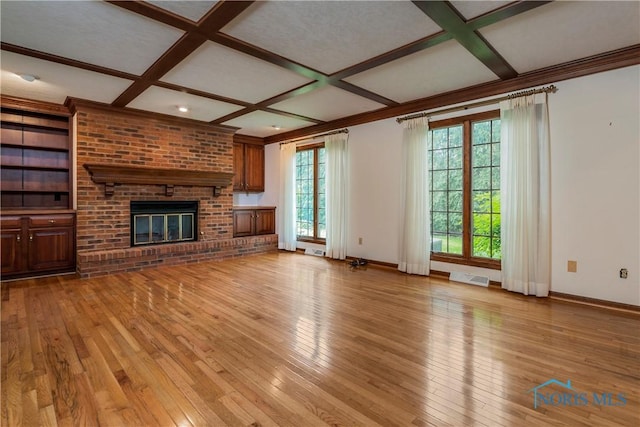 5301 River Oaks Ct, Sylvania, OH 43560 - unfurnished living room with coffered ceiling, light wood finished floors, a brick fireplace, and beam ceiling