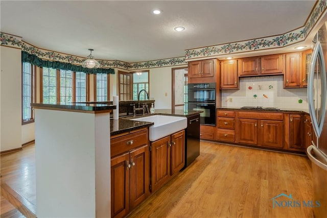 5301 River Oaks Ct, Sylvania, OH 43560 - kitchen with black appliances, brown cabinetry, plenty of natural light, and recessed lighting