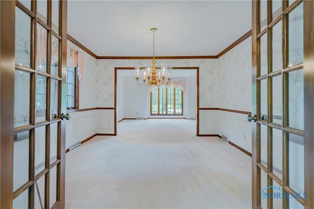 5301 River Oaks Ct, Sylvania, OH 43560 - unfurnished dining area featuring crown molding, a chandelier, wallpapered walls, a wainscoted wall, and a decorative wall
