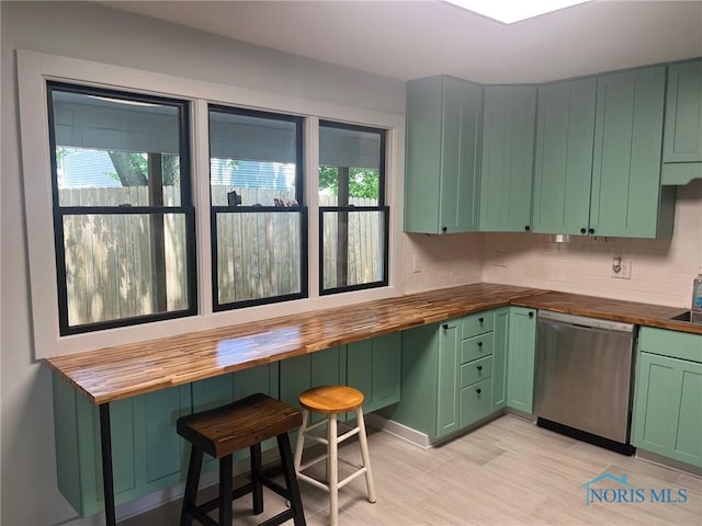 611 Greenfield Dr, Maumee, OH 43537 - kitchen with wooden counters, stainless steel dishwasher, green cabinetry, and healthy amount of natural light