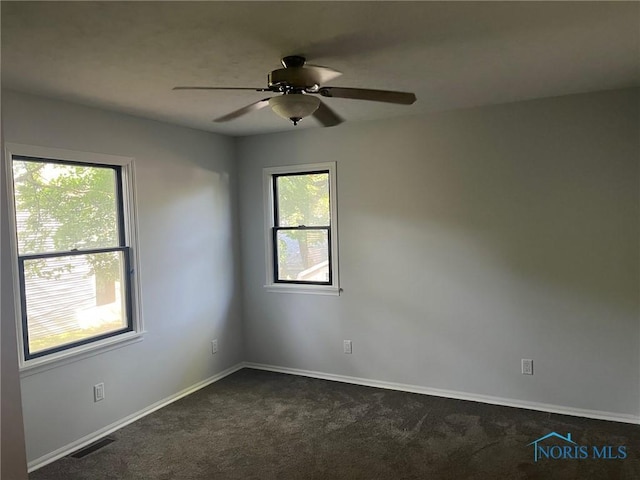 611 Greenfield Dr, Maumee, OH 43537 - unfurnished room featuring plenty of natural light, dark carpet, and a ceiling fan