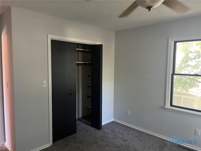 611 Greenfield Dr, Maumee, OH 43537 - unfurnished bedroom with dark colored carpet, a closet, and ceiling fan