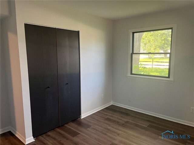 611 Greenfield Dr, Maumee, OH 43537 - unfurnished bedroom featuring dark wood finished floors and a closet