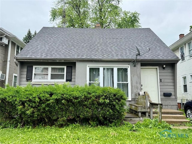 4244 N Lockwood Ave, Toledo, OH 43612 - view of front facade with roof with shingles and a chimney