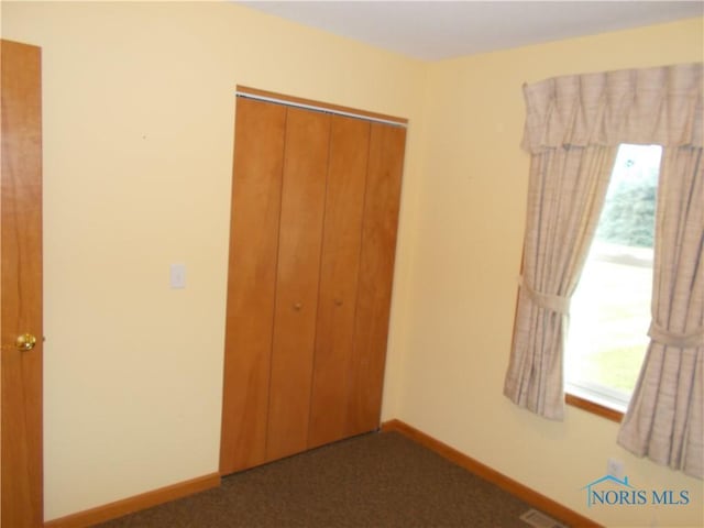 2971 County Road 12, Wauseon, OH 43567 - unfurnished bedroom featuring multiple windows, a closet, and carpet