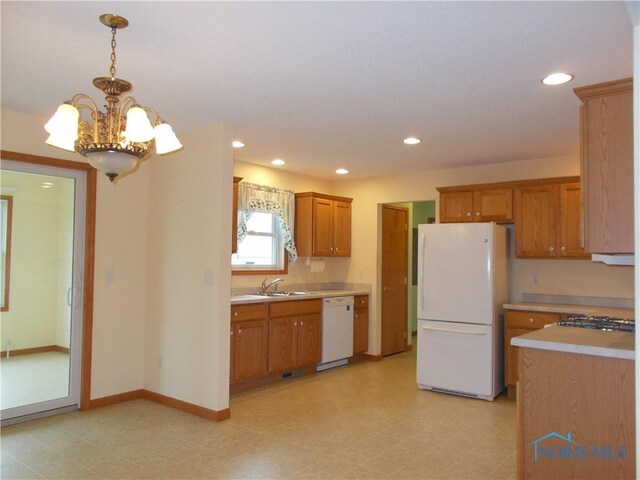 2971 County Road 12, Wauseon, OH 43567 - kitchen with white appliances, light countertops, brown cabinetry, a chandelier, and recessed lighting