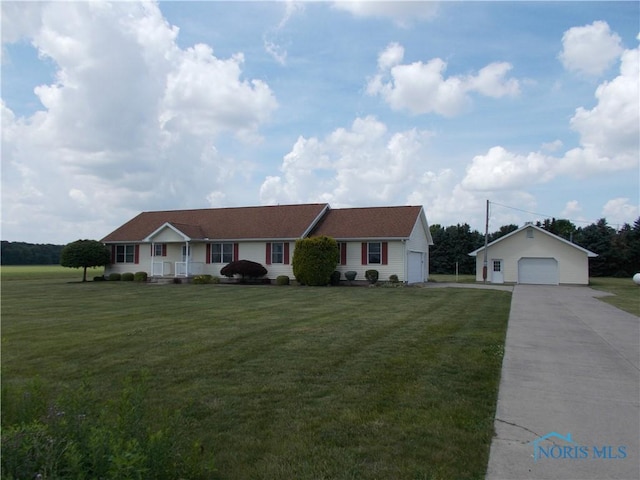 2971 County Road 12, Wauseon, OH 43567 - ranch-style house featuring a detached garage, concrete driveway, a front yard, and an outdoor structure