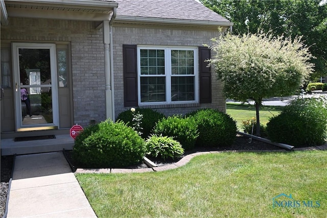 4547 Harbour Creek Ct, Maumee, OH 43537 - view of property exterior with brick siding, a yard, and roof with shingles