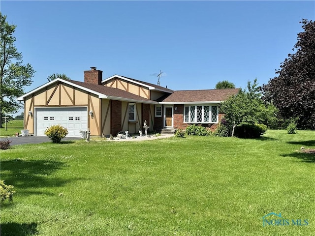 410 E Bartlow St, Deshler, OH 43516 - view of front facade with an attached garage, a front lawn, a chimney, and driveway