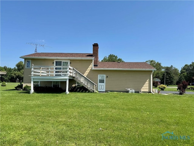 410 E Bartlow St, Deshler, OH 43516 - rear view of house featuring a lawn, a chimney, a deck, and stairway