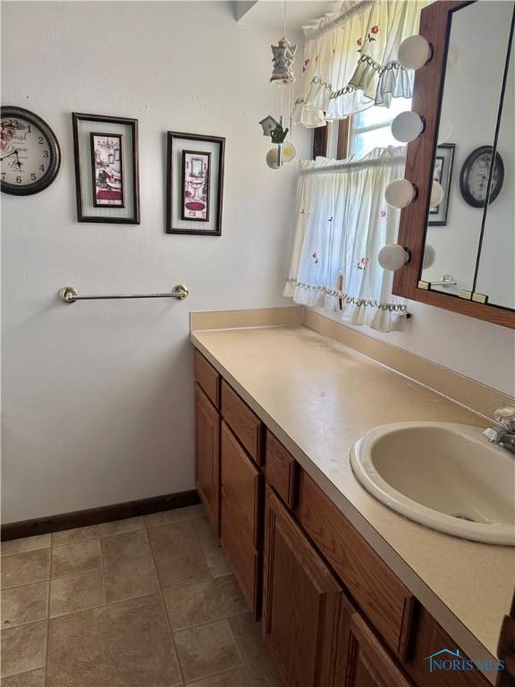 410 E Bartlow St, Deshler, OH 43516 - bathroom featuring vanity and baseboards