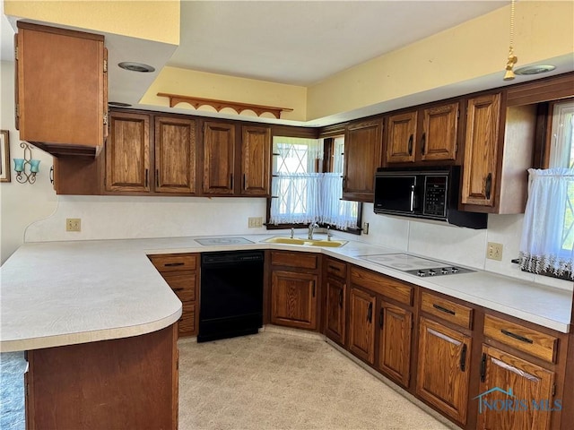 410 E Bartlow St, Deshler, OH 43516 - kitchen featuring black appliances, light countertops, and a peninsula