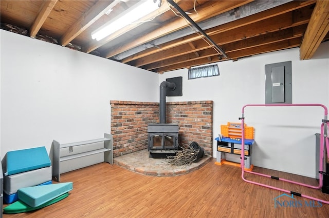 28713 Starlight Rd, Perrysburg, OH 43551 - finished below grade area featuring electric panel, wood finished floors, and a wood stove