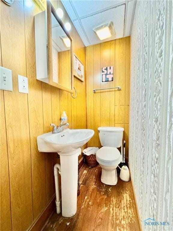 620 Division St, Defiance, OH 43512 - half bath featuring wood finished floors and wooden walls