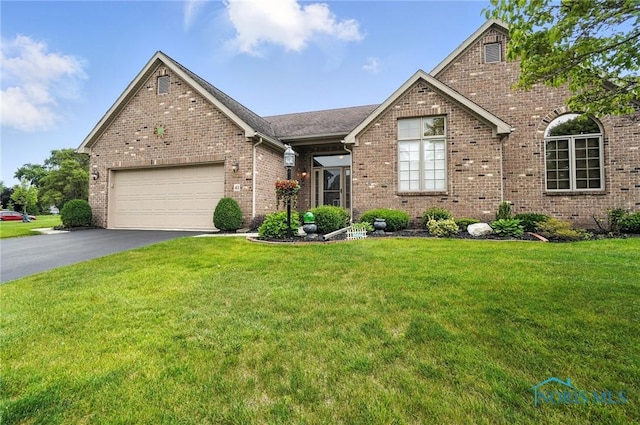 41 Shenandoah Cir, Sylvania, OH 43560 - view of front of house featuring driveway, an attached garage, a front lawn, and brick siding