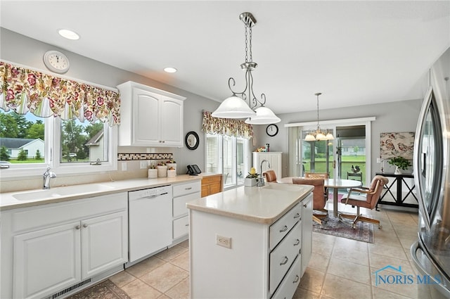 41 Shenandoah Cir, Sylvania, OH 43560 - kitchen with dishwasher, a kitchen island, white cabinets, freestanding refrigerator, and a chandelier