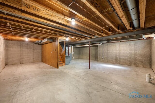 14691 Ramblehurst Dr, Perrysburg, OH 43551 - unfinished basement with stairs and brick wall