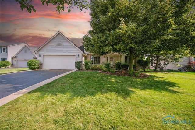 14691 Ramblehurst Dr, Perrysburg, OH 43551 - view of front of home featuring asphalt driveway, a garage, and a yard