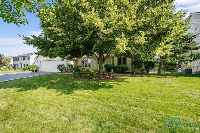 14691 Ramblehurst Dr, Perrysburg, OH 43551 - view of front of house with asphalt driveway, a front lawn, and an attached garage