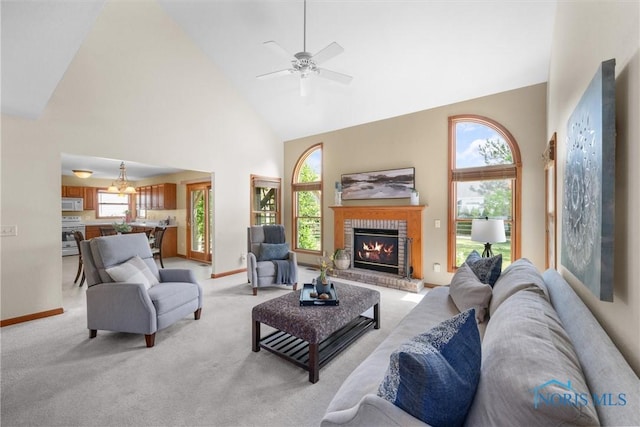 14691 Ramblehurst Dr, Perrysburg, OH 43551 - living room with high vaulted ceiling, a fireplace, a ceiling fan, and light carpet