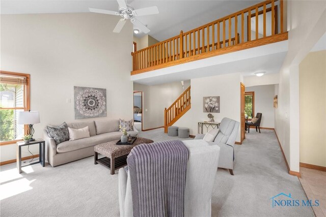 14691 Ramblehurst Dr, Perrysburg, OH 43551 - carpeted living area featuring high vaulted ceiling, stairs, and a ceiling fan